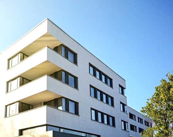 A white building with many windows and balconies.