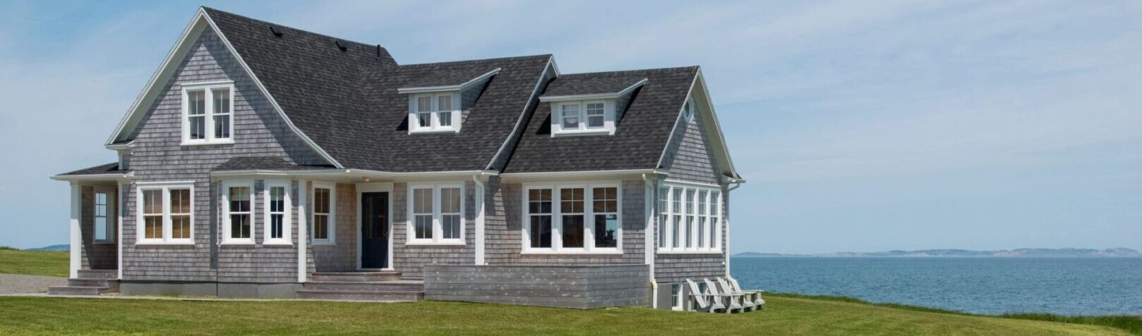 A house with two windows and a roof that has been cut off.